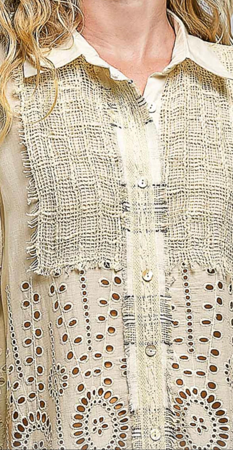 Close-up of a textured beige shirt with floral patterns
