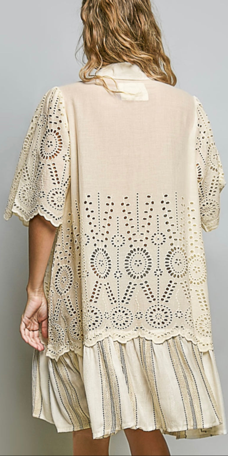 Beige lace kimono-style garment worn by a model on a gray background